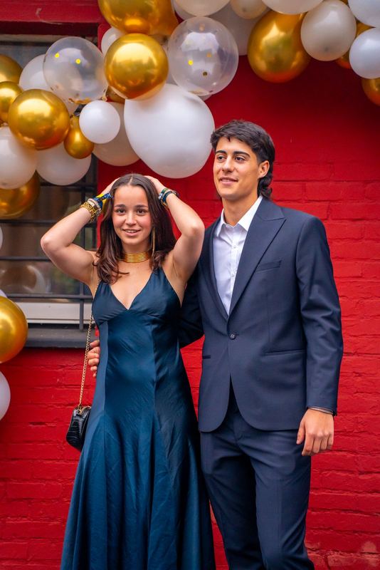 Bal promo 2029, portrait d'un couple en tenue de soirée devant l'arche de ballons